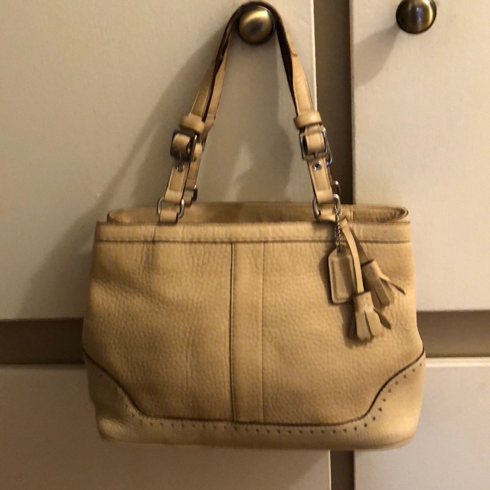 Beige pebble leather coach bag.